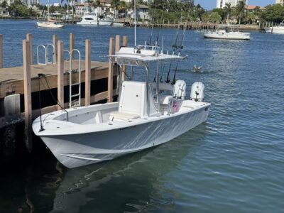 White center console fishing boat at dock.